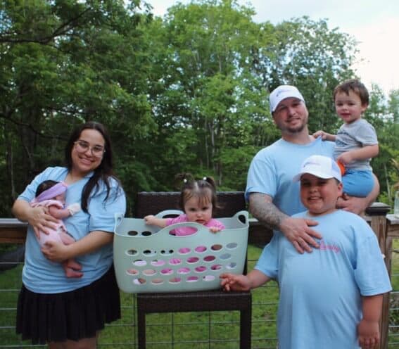 The O'Hanlon family in matching Lillie's Laundry shirts around a laundry basket