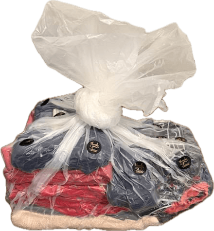 Folded laundry order bagged with thank you stickers
